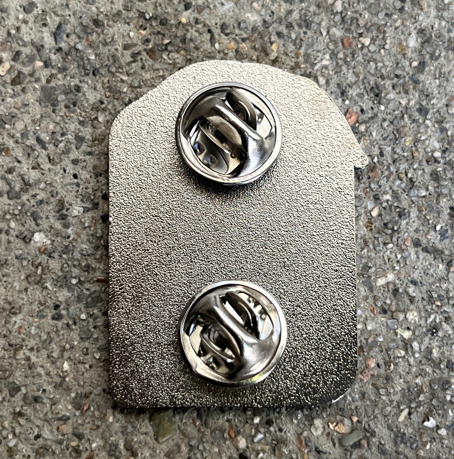 REI black nickel enamel pin